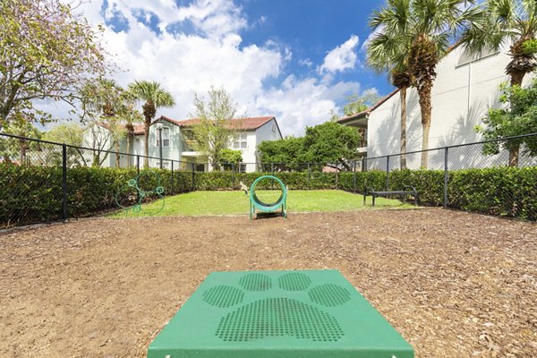 Spacious dog park with agility equipment at Mira Flores Apartments offering a pet-friendly community experience