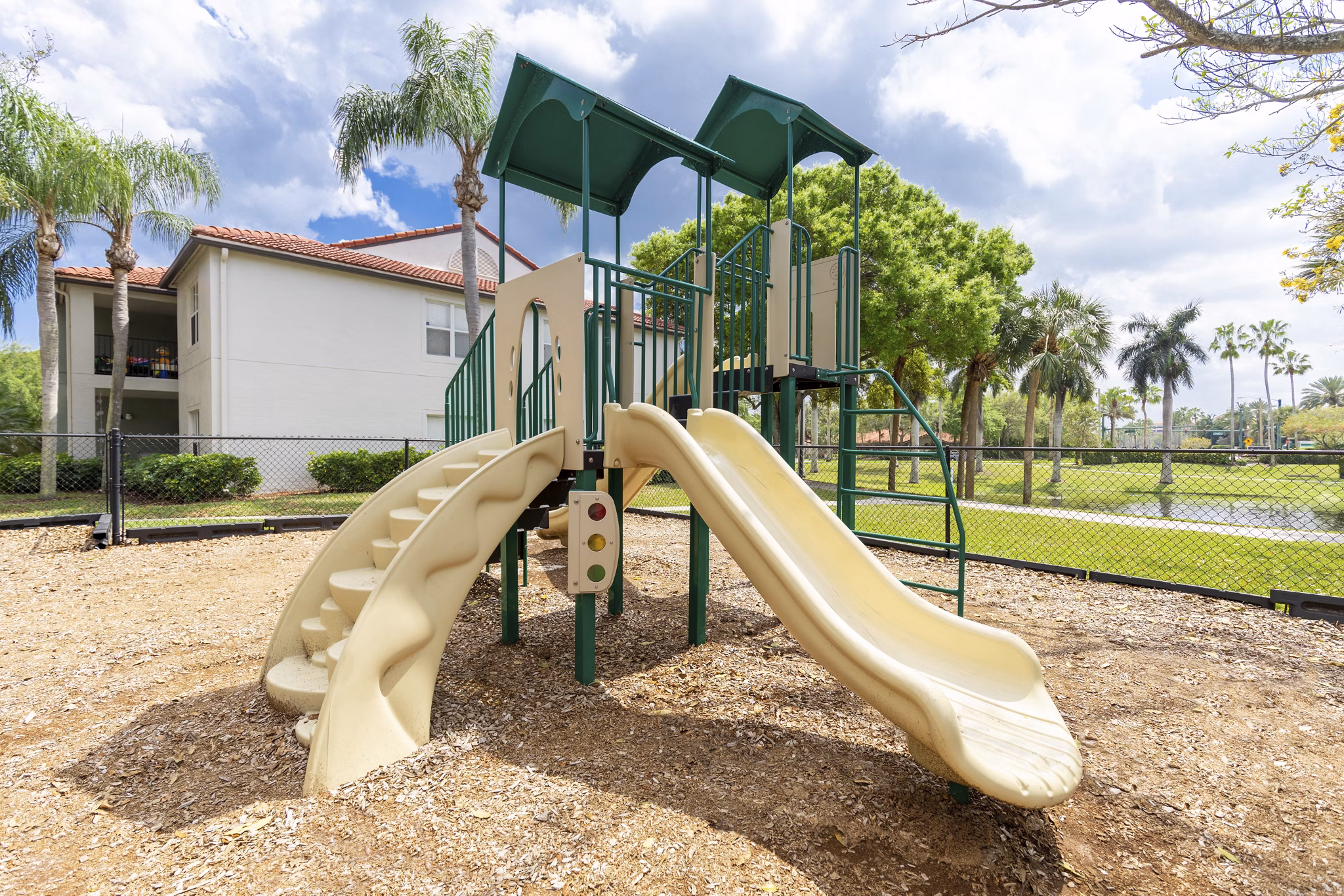 Mira Flores Apartments: Modern playground with slides and climbing structures, offering family-friendly amenities