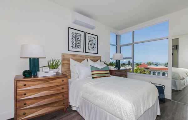 Spacious bedroom with plush bedding at The Dwight luxury apartments
