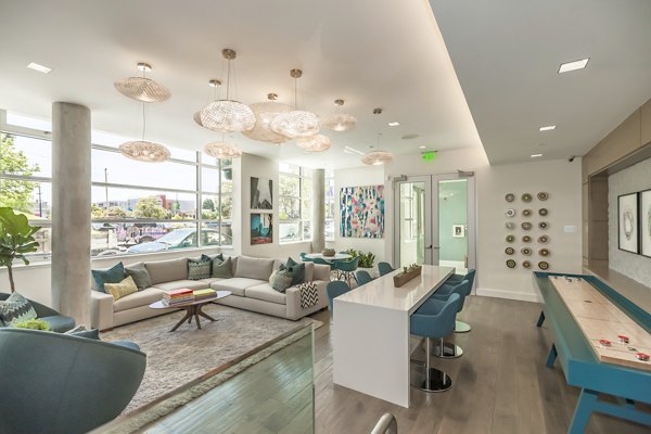 Elegant clubhouse featuring modern decor and ample seating at The Dwight luxury apartments