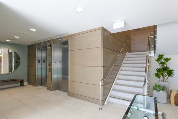 The Dwight: Elegant hallway with contemporary lighting and art pieces, showcasing luxury apartment design