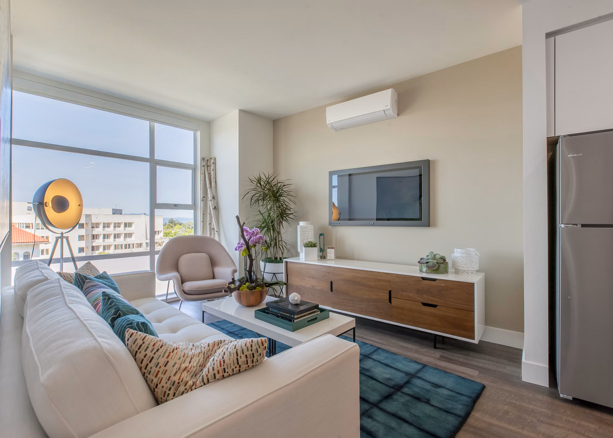 Spacious living room with modern decor and ample natural light at The Dwight luxury apartments