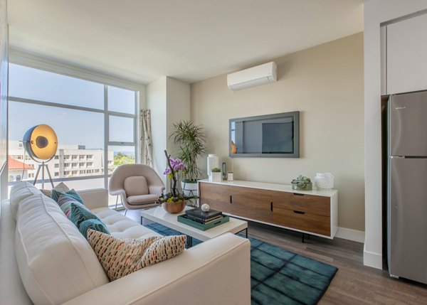 Spacious living room with modern decor and ample natural light at The Dwight luxury apartments