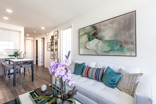 Spacious living room with modern furnishings at The Dwight luxury apartments 15941LIV3
