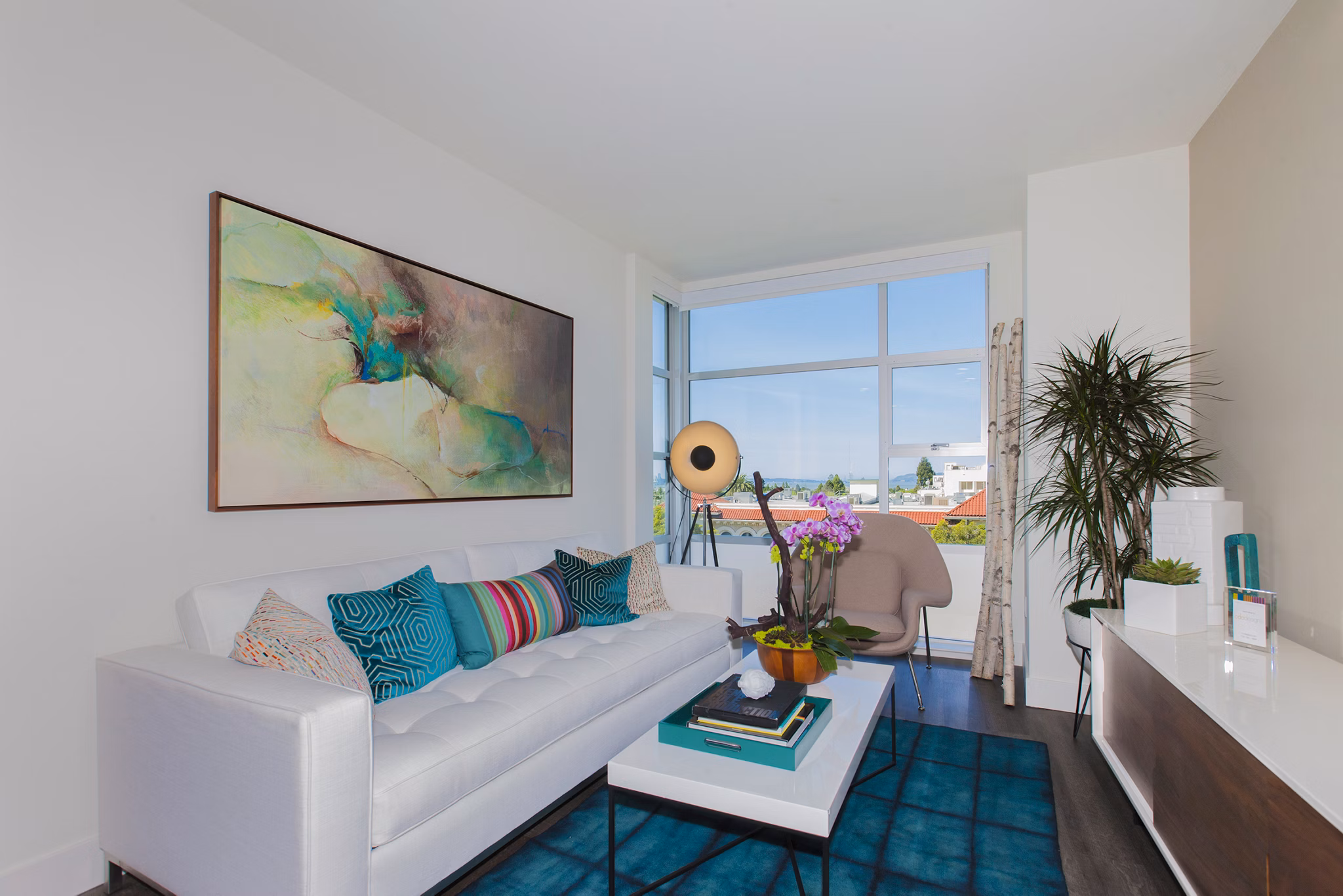 Modern living room with sleek furnishings and large windows at The Dwight apartments