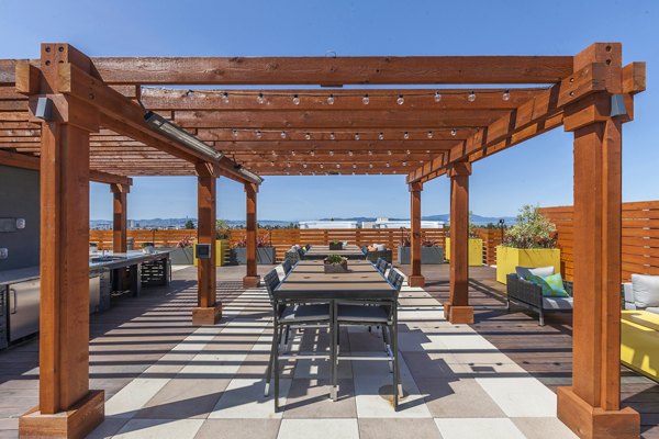Grill area with modern seating at The Dwight luxury apartments, perfect for outdoor gatherings and relaxation