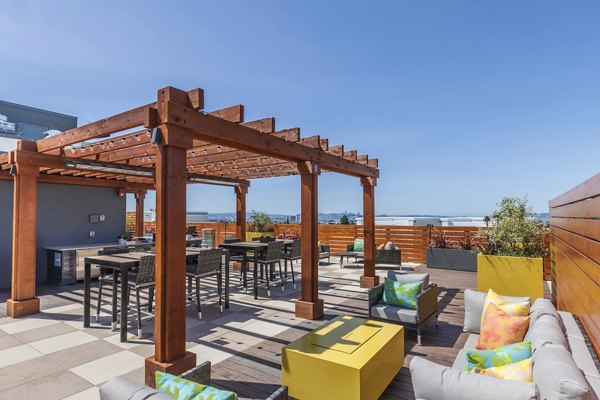Outdoor social space with a modern grill area at The Dwight luxury apartments