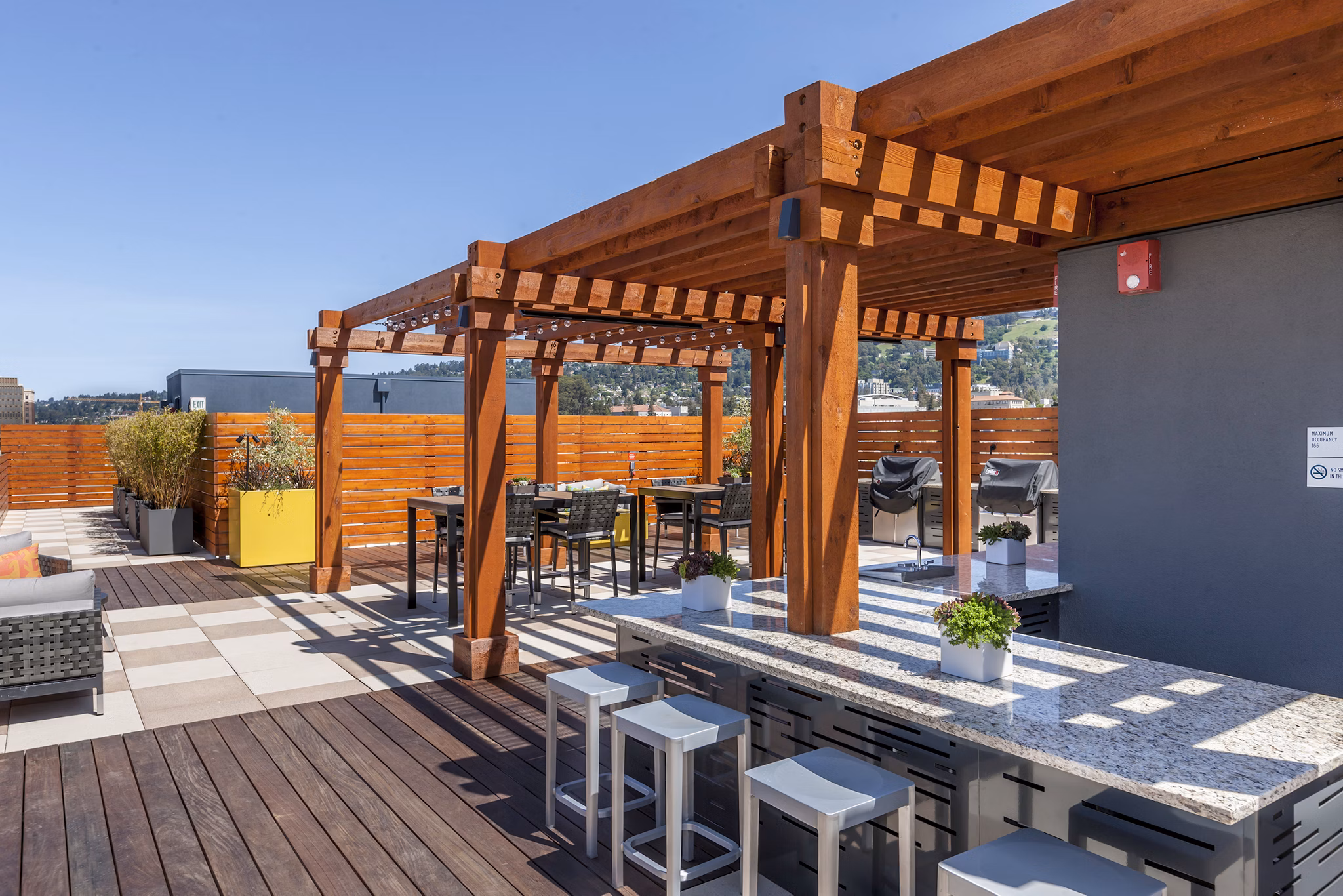 Outdoor grill area with modern seating at The Dwight apartments