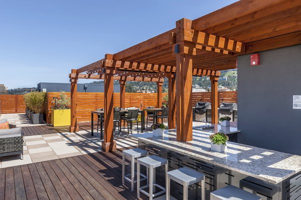 Outdoor grill area with modern seating at The Dwight apartments