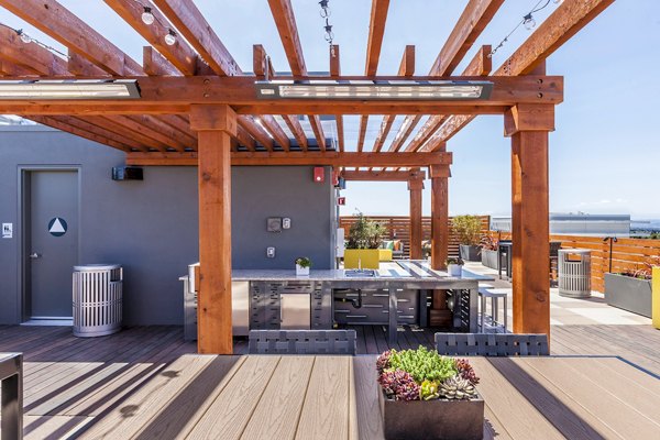 Outdoor grill area at The Dwight: Modern grilling stations with seating, ideal for socializing and relaxation in a luxury apartment community