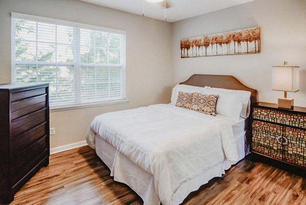Spacious bedroom with contemporary furnishings in Finley at Fairfax Corner apartments
