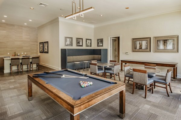 Modern clubhouse game room with pool tables and lounge seating at Finley at Fairfax Corner luxury apartments