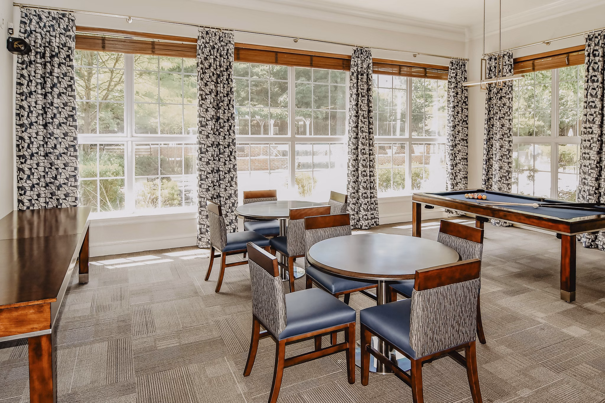 Clubhouse game room featuring billiards and lounge seating at Finley at Fairfax Corner luxury apartments