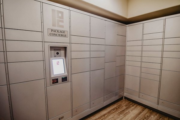 Secure parcel package pickup locker facility at Finley at Fairfax Corner luxury apartments in a modern residential community