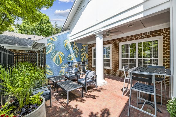 Spacious patio with seating and lush greenery at Finley at Fairfax Corner Apartments in a serene setting