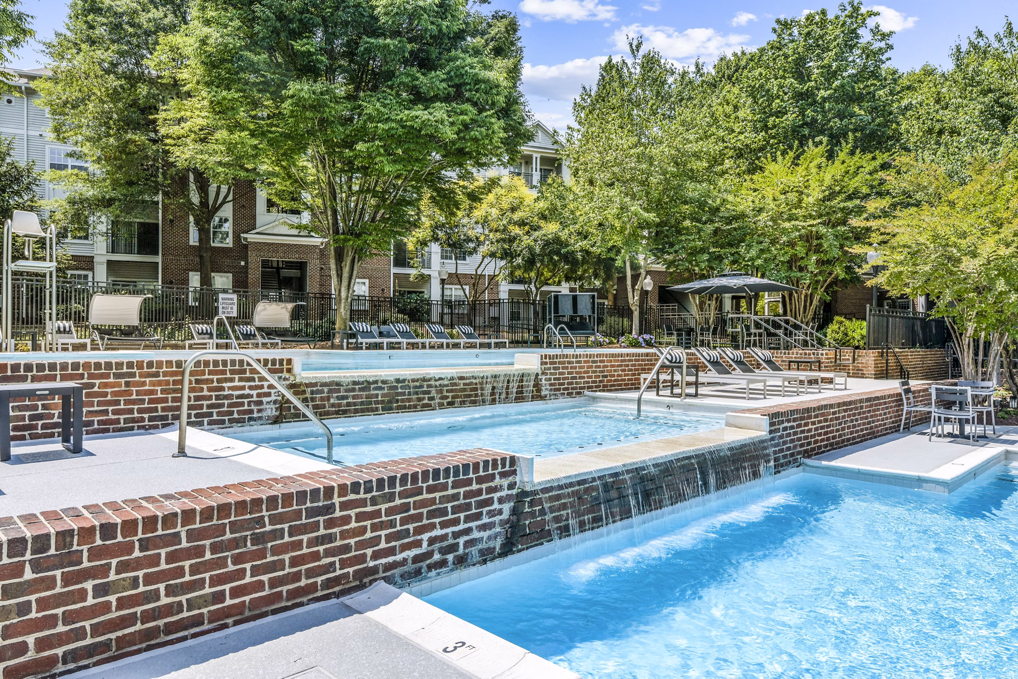 Relaxing poolside retreat at Finley at Fairfax Corner Apartments featuring cabanas and sundeck