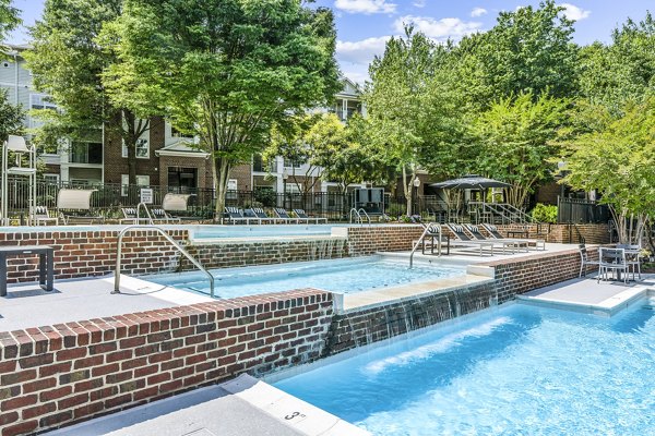 Relaxing poolside retreat at Finley at Fairfax Corner Apartments featuring cabanas and sundeck