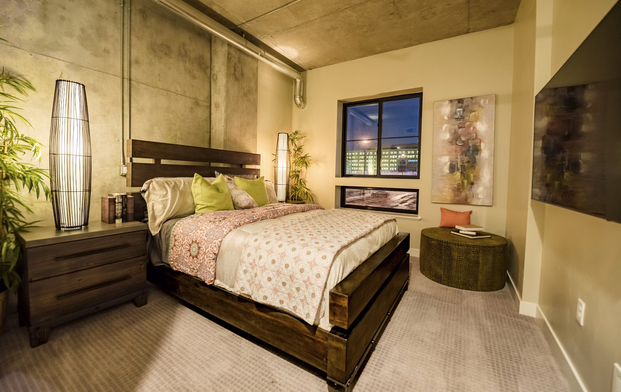 Cozy bedroom with modern decor at Hardware Village Apartments
