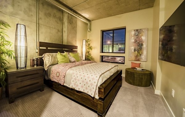 Cozy bedroom with modern decor at Hardware Village Apartments