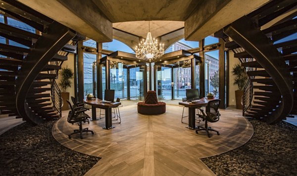 Modern clubhouse with sleek design at Hardware Village Apartments, featuring cozy seating and spacious meeting areas
