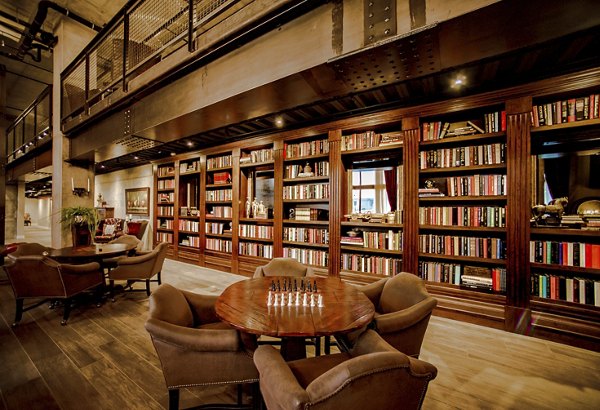 Modern clubhouse featuring lounge seating and billiards at Hardware Village Apartments, a luxury community in downtown Salt Lake City
