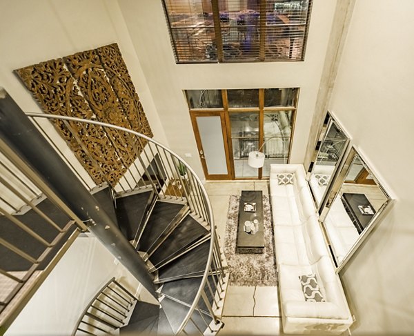 Modern kitchen with stainless steel appliances in Hardware Village Apartments luxury complex