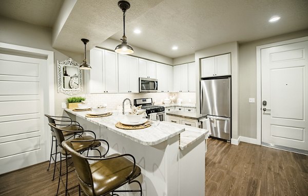 Modern kitchen with sleek cabinetry and stainless steel appliances at Hardware Village Apartments, Greystar luxury apartments in Salt Lake City