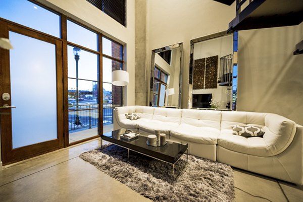 Modern living room with stylish decor at Hardware Village Apartments, featuring contemporary furniture and ample natural light