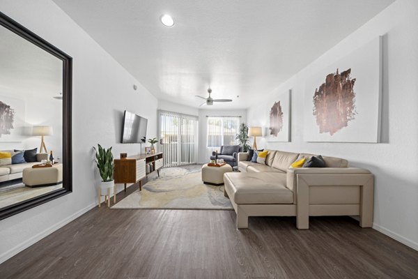 Cozy living room with modern decor at Monterra Apartments, featuring plush seating and open layout