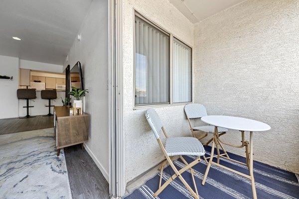 Monterra Apartments: Spacious patio surrounded by lush greenery, perfect for relaxation