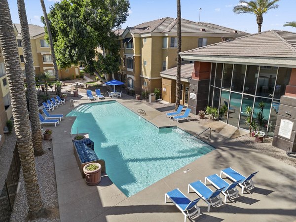 Luxurious pool with palm trees at Monterra Apartments in sunny California