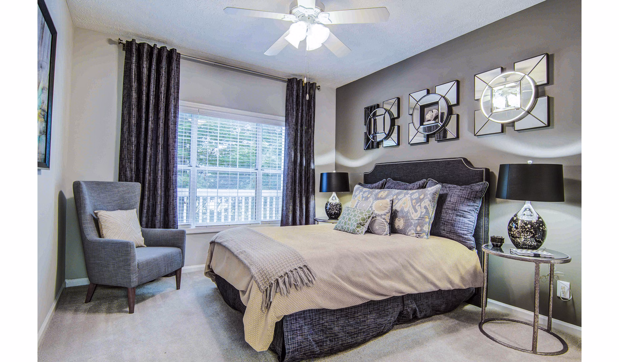 Master bedroom featuring elegant decor at The Prato at Midtown Apartments