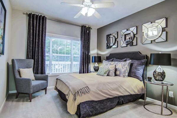 Master bedroom featuring elegant decor at The Prato at Midtown Apartments