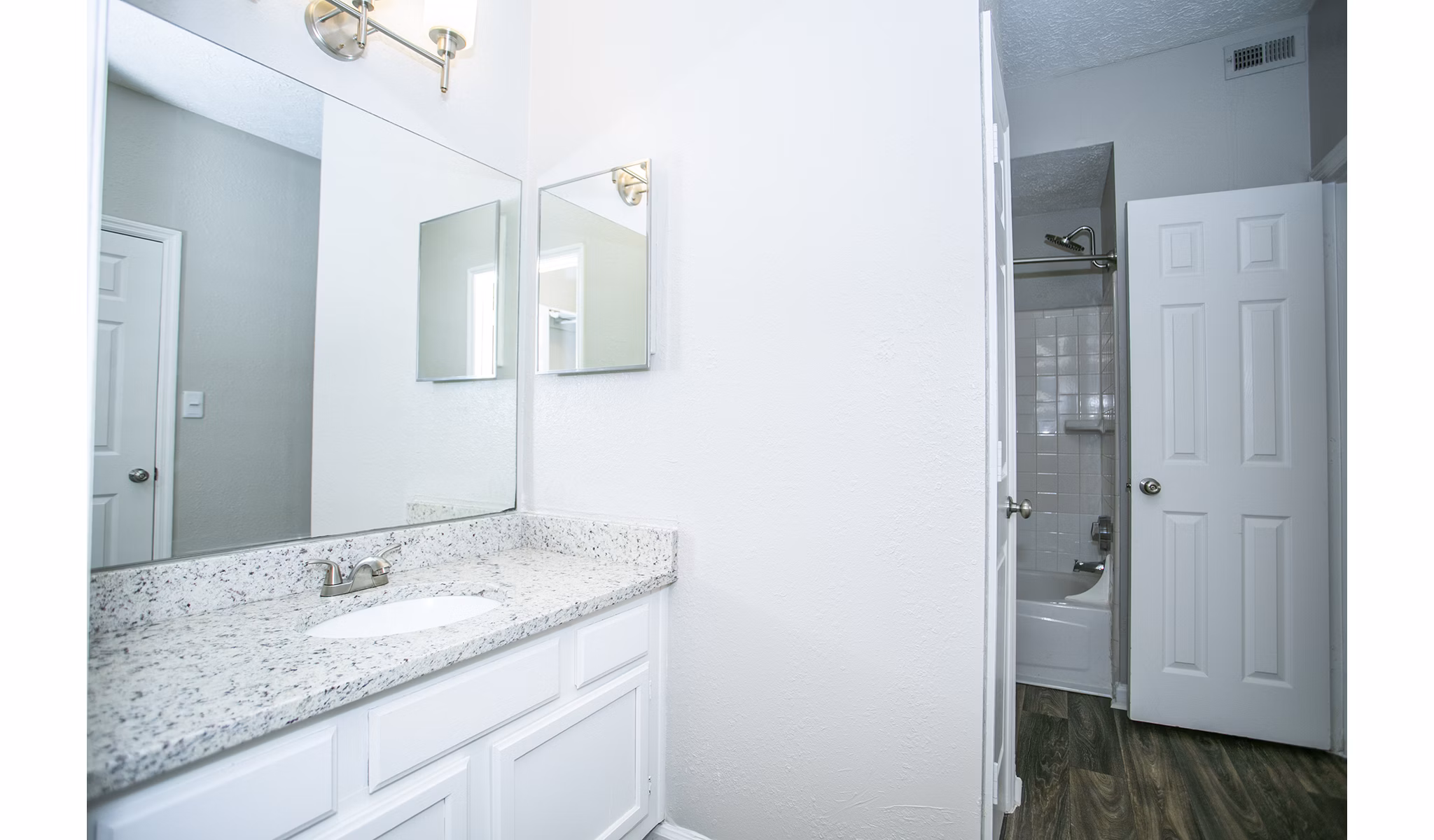 Bathroom with sleek vanity and modern fixtures at The Prato at Midtown Apartments