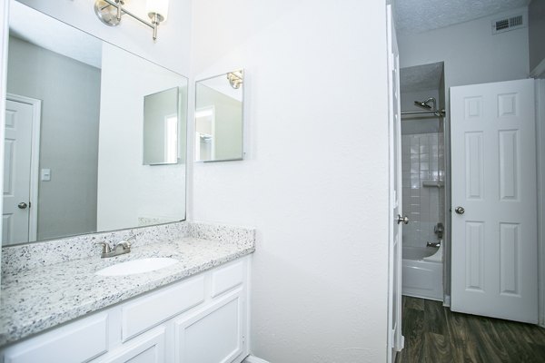 Bathroom with sleek vanity and modern fixtures at The Prato at Midtown Apartments