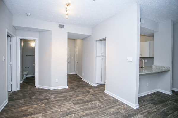 Dining room with elegant chandelier and modern furnishings at The Prato at Midtown Apartments