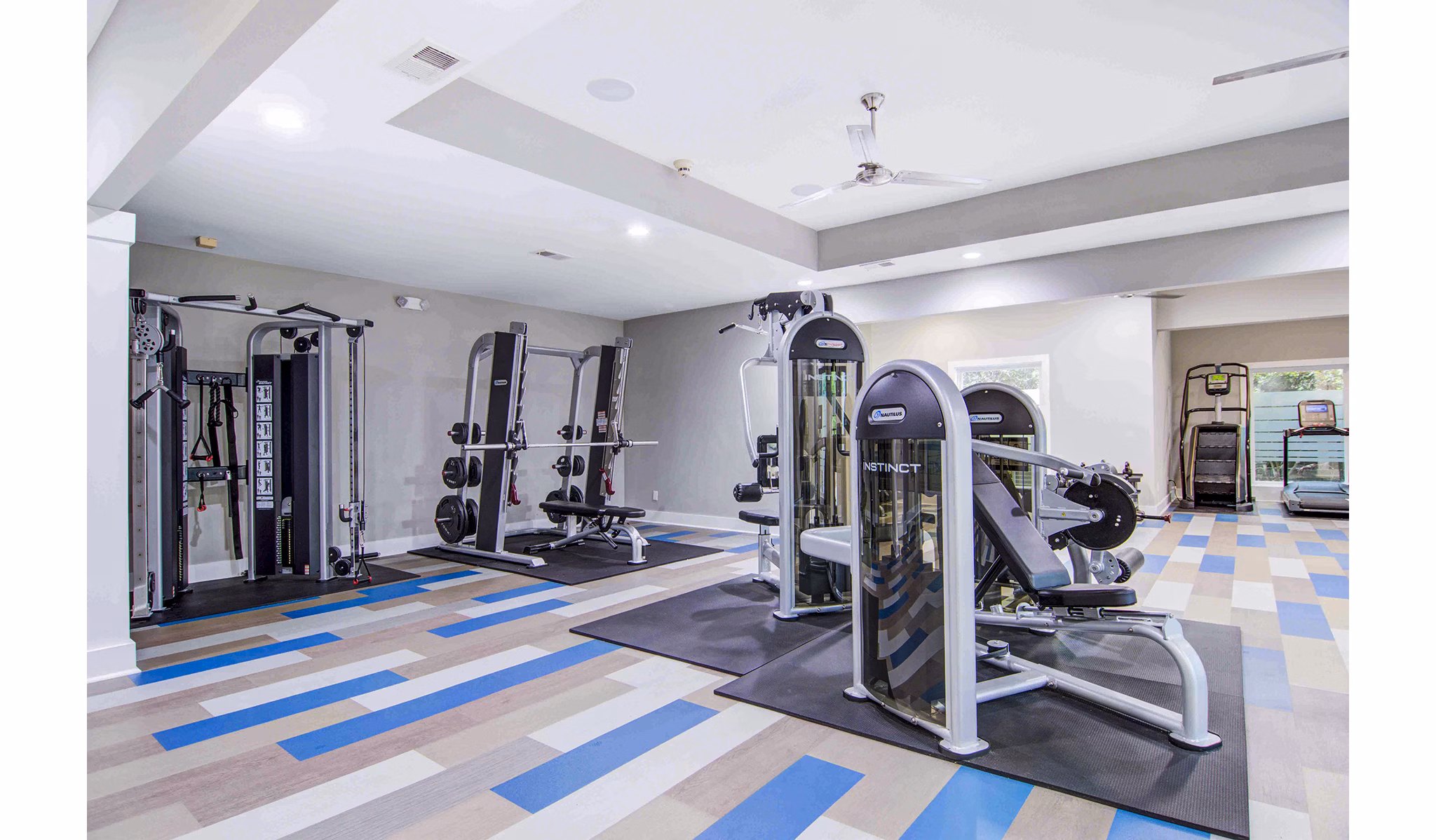 Fitness center with modern equipment at The Prato at Midtown Apartments