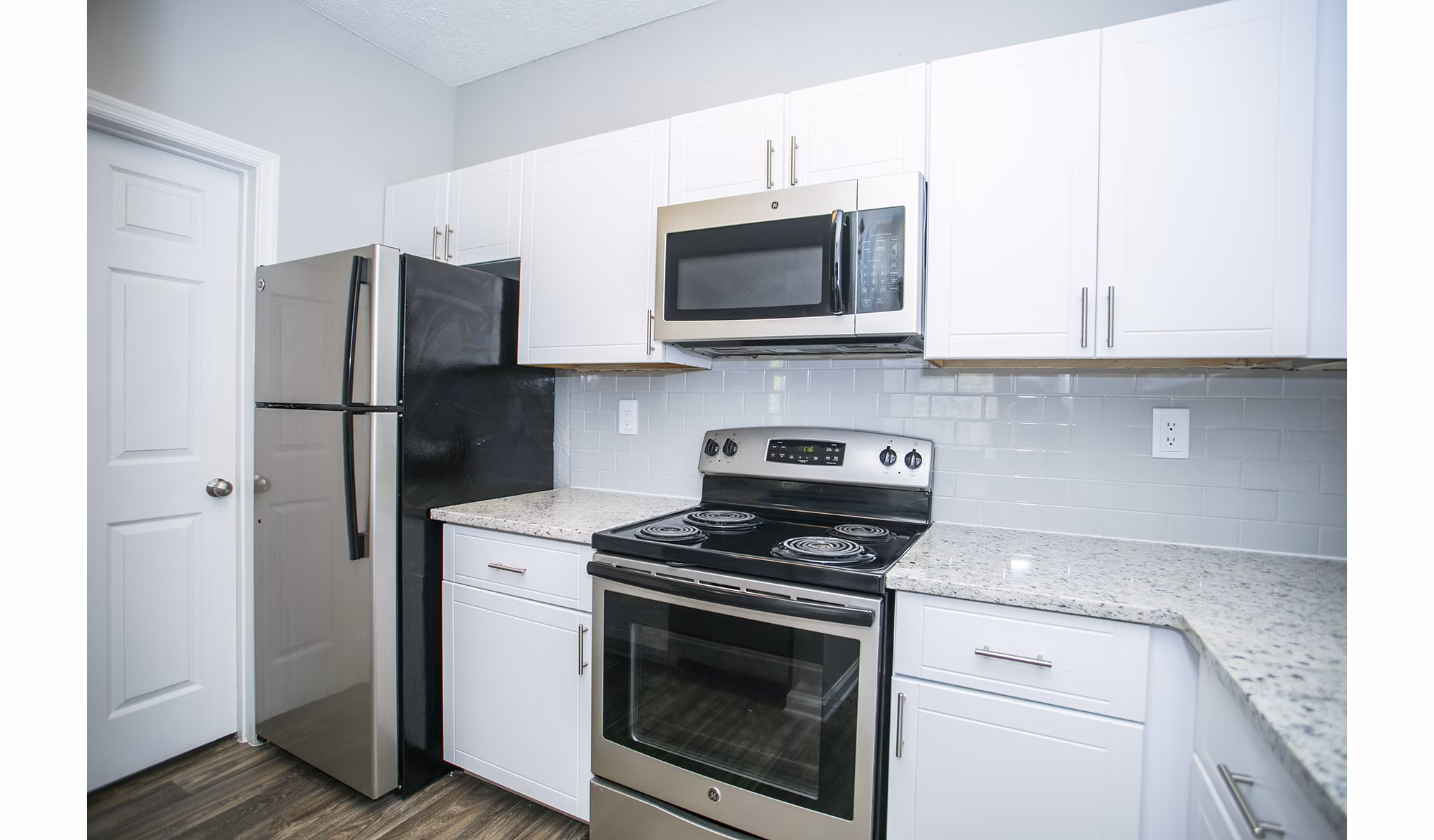 Modern kitchen featuring sleek cabinetry and stainless steel appliances at The Prato at Midtown Apartments