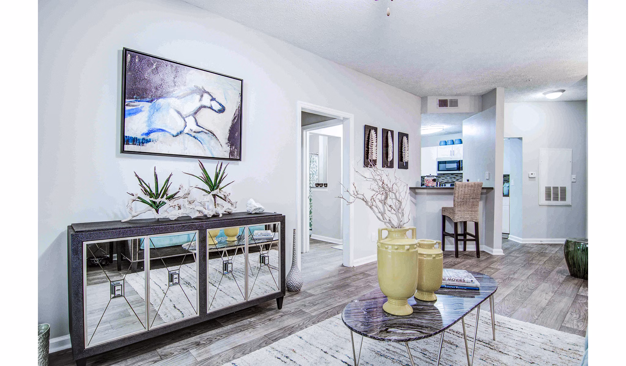 Bright living room with modern furnishings at The Prato at Midtown Apartments
