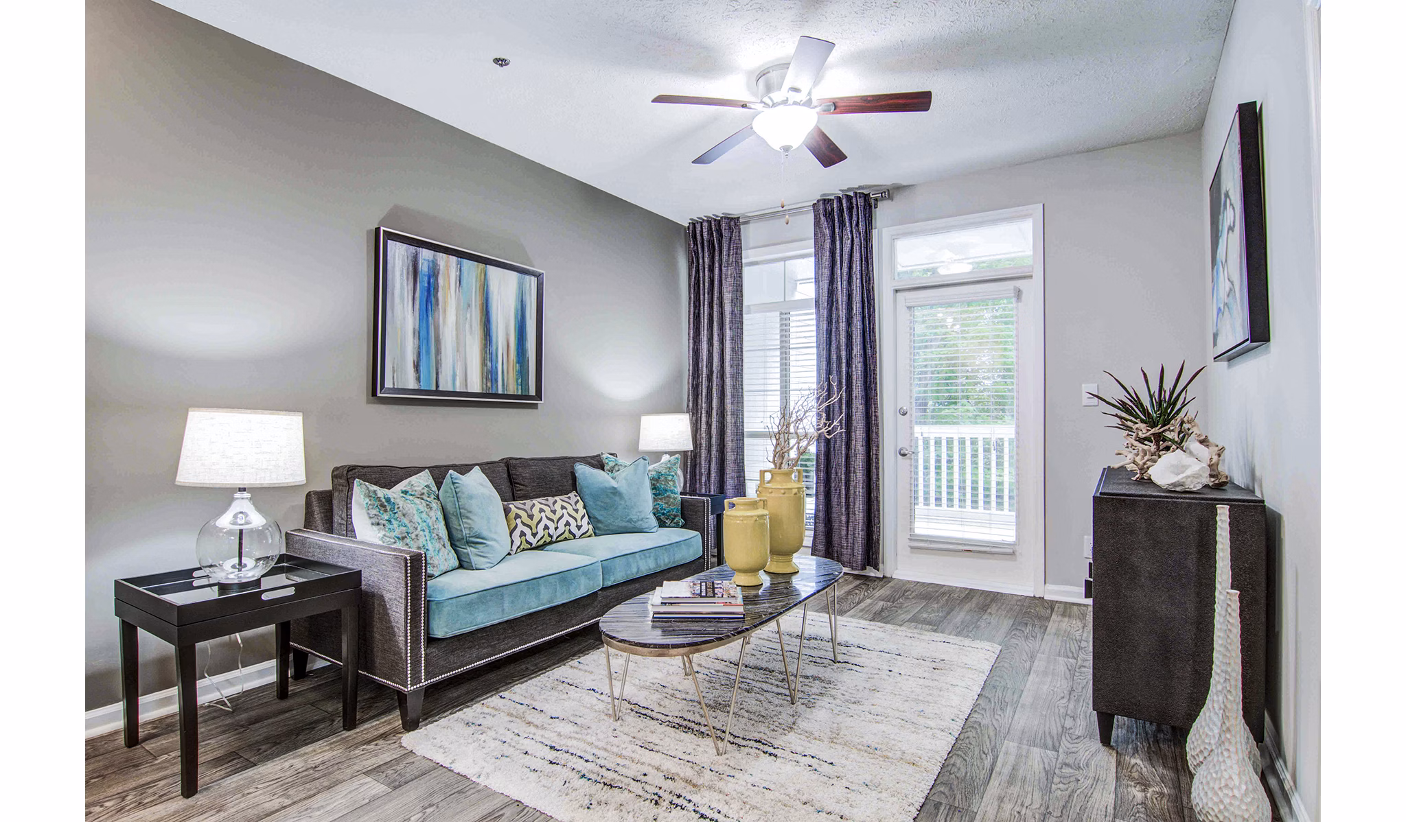 Spacious living room with modern decor at The Prato at Midtown Apartments