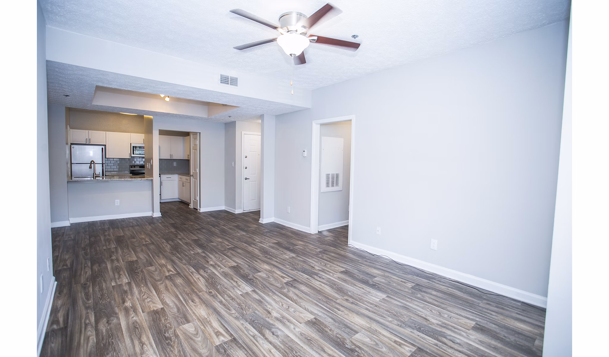 Spacious living room with modern decor at The Prato at Midtown Apartments