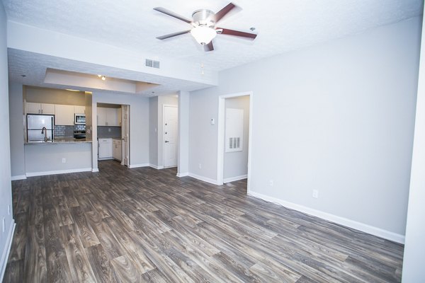 Spacious living room with modern decor at The Prato at Midtown Apartments