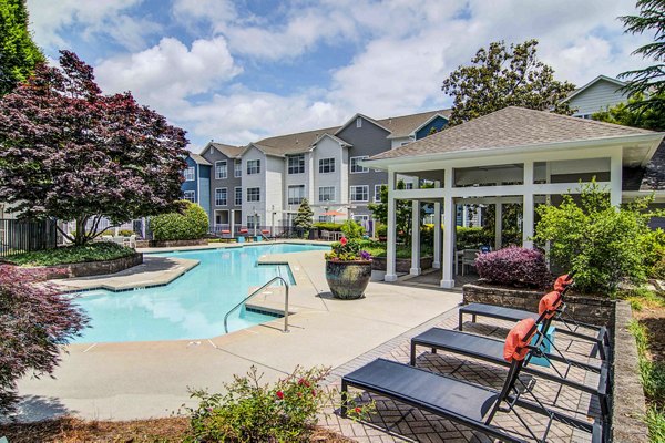 Relaxing pool area with sun loungers at The Prato at Midtown Apartments