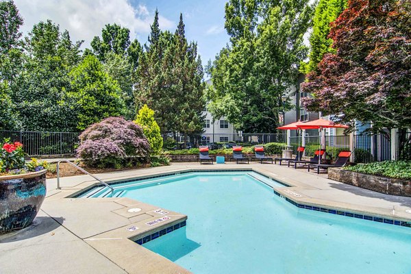 Luxurious pool with sun loungers at The Prato at Midtown Apartments