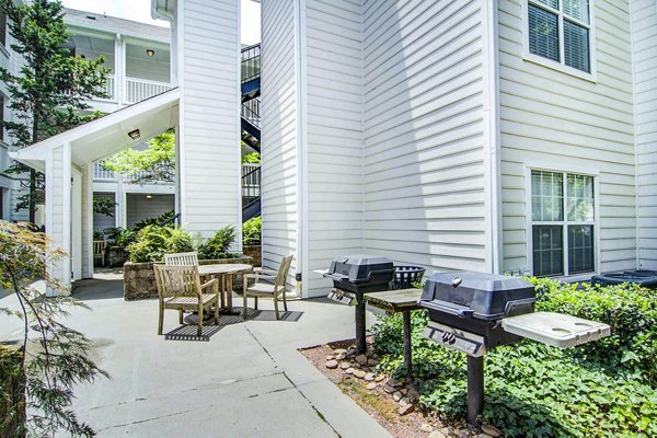 Outdoor grill area with modern seating at The Prato at Midtown Apartments