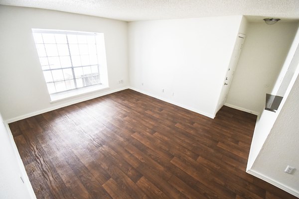 Modern kitchen with granite countertops and stainless steel appliances at Waterloo Flats Apartments