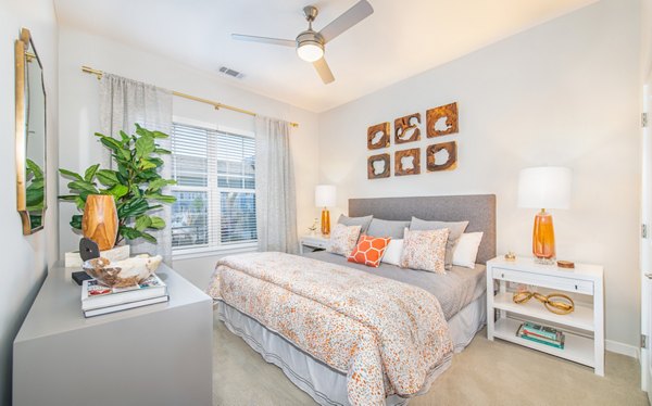 Bedroom with modern design and large windows at Overture Centennial Apartments for luxurious living