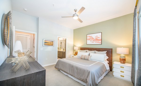 Modern bedroom with stylish decor and large windows at Overture Centennial Apartments, luxury living space