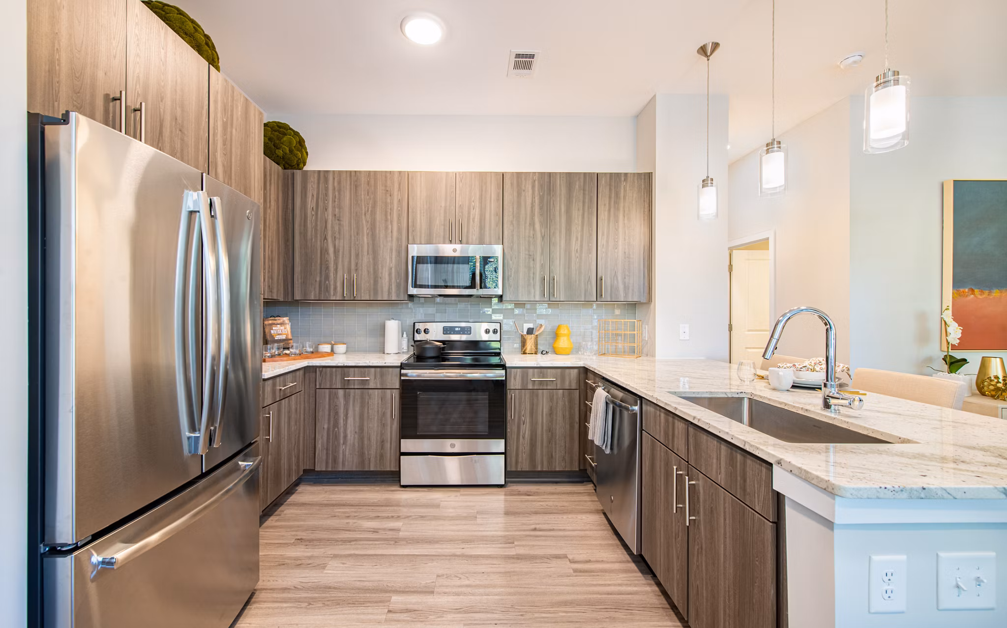 Modern kitchen with sleek cabinetry and stainless appliances at Overture Centennial Apartments, luxury living by Greystar