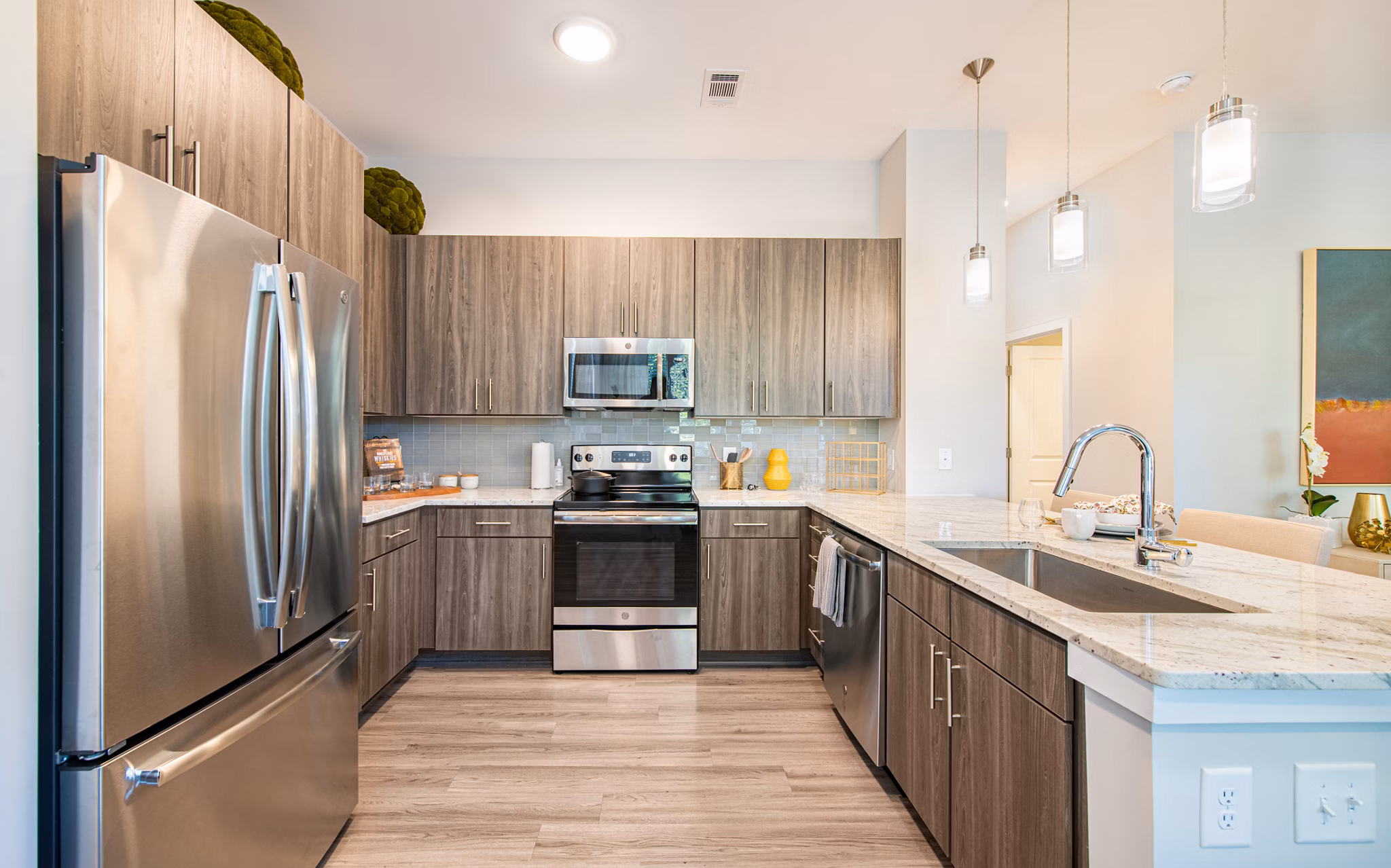 Modern kitchen with sleek cabinetry and stainless appliances at Overture Centennial Apartments, luxury living by Greystar